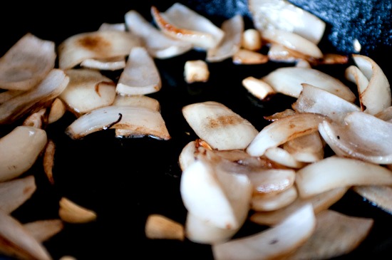 onions in pan cooking onions in cast iron skillet