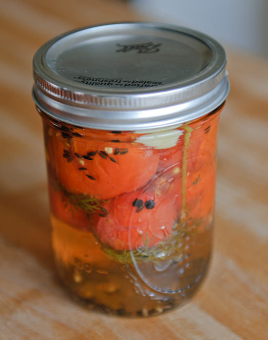 pickled tomatoes close up of pickled cherry tomatoes in a ball jar
