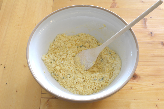 an image of a bowl containing a mixture of flour, lemon zest, and thyme leaves