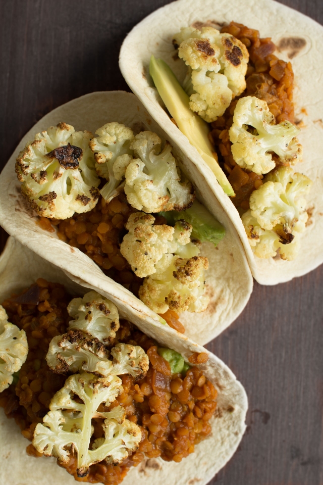 tacos filled with roasted cauliflower, spicy lentils, sultanas and avocado