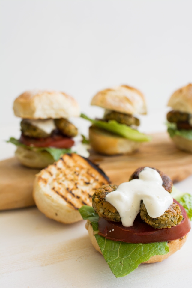 close-up image of a falafel burger, revealing the textured inner mixture.