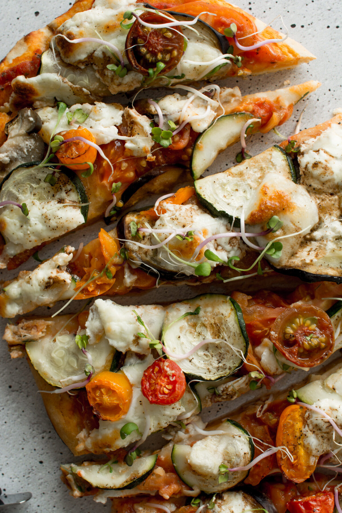 top view of sliced Mediterranean No-Rise Scone-Based Pizza, showcasing creamy burrata and garnished with fresh sprouts