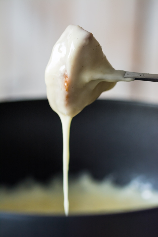 a single cut of bread dipped into the cheese fondue mixture